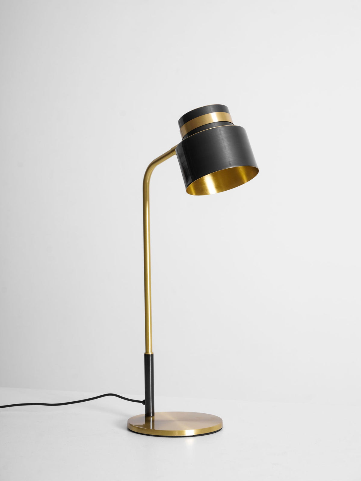 Front three-quarter view of this Clérachic table lamp on a pale backdrop, with its gold-lined shade turned toward you.
