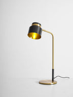 This Clérachic table lamp seen from the side, with the shade turned to show its brass-coloured inside.