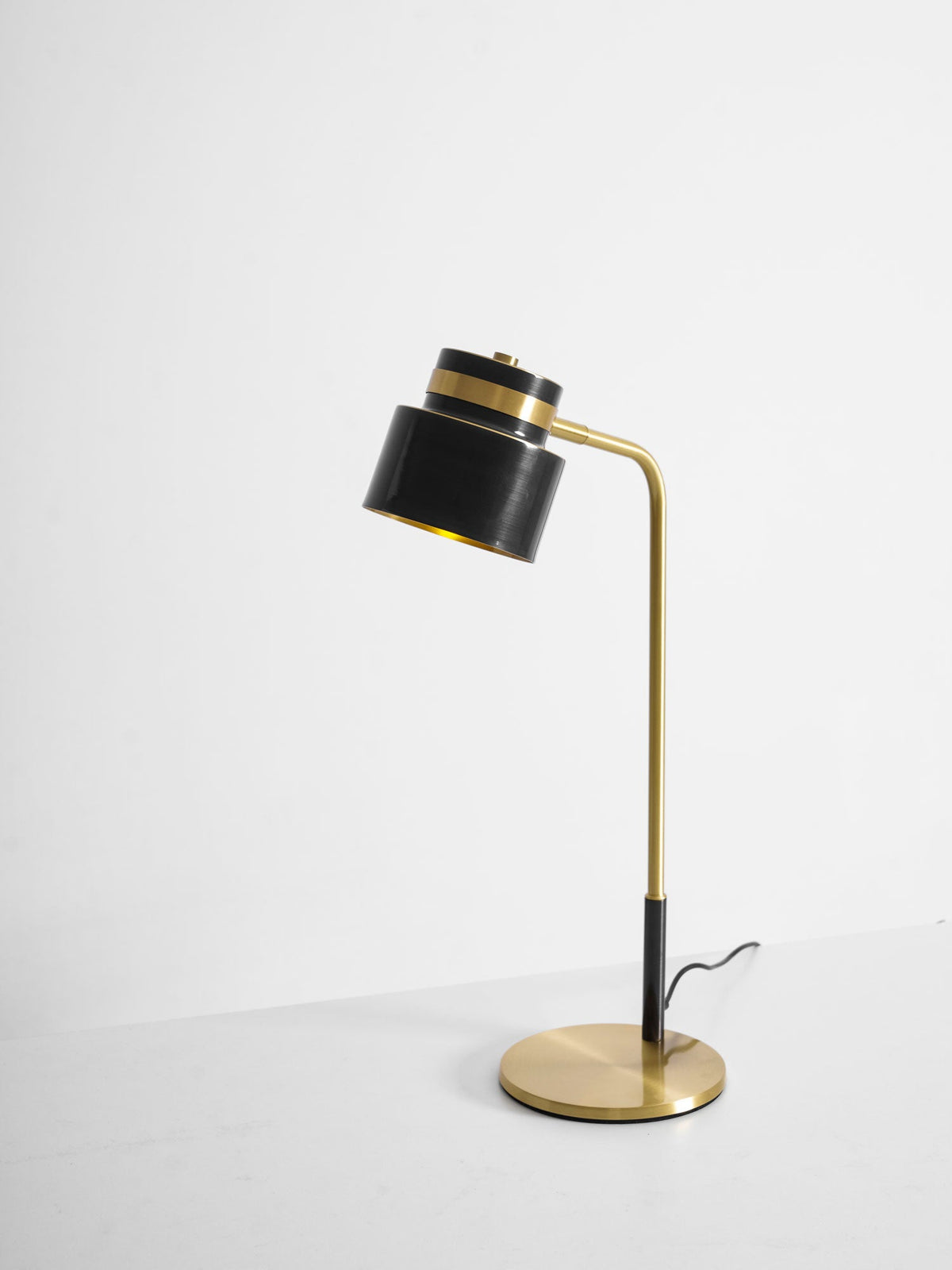 A Clérachic table lamp on a plain light backdrop, with a short stretch of cord by the base and the shade facing left.