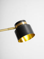 Close view of the open end of the shade on this Clérachic table lamp, showing its brass-toned lining.