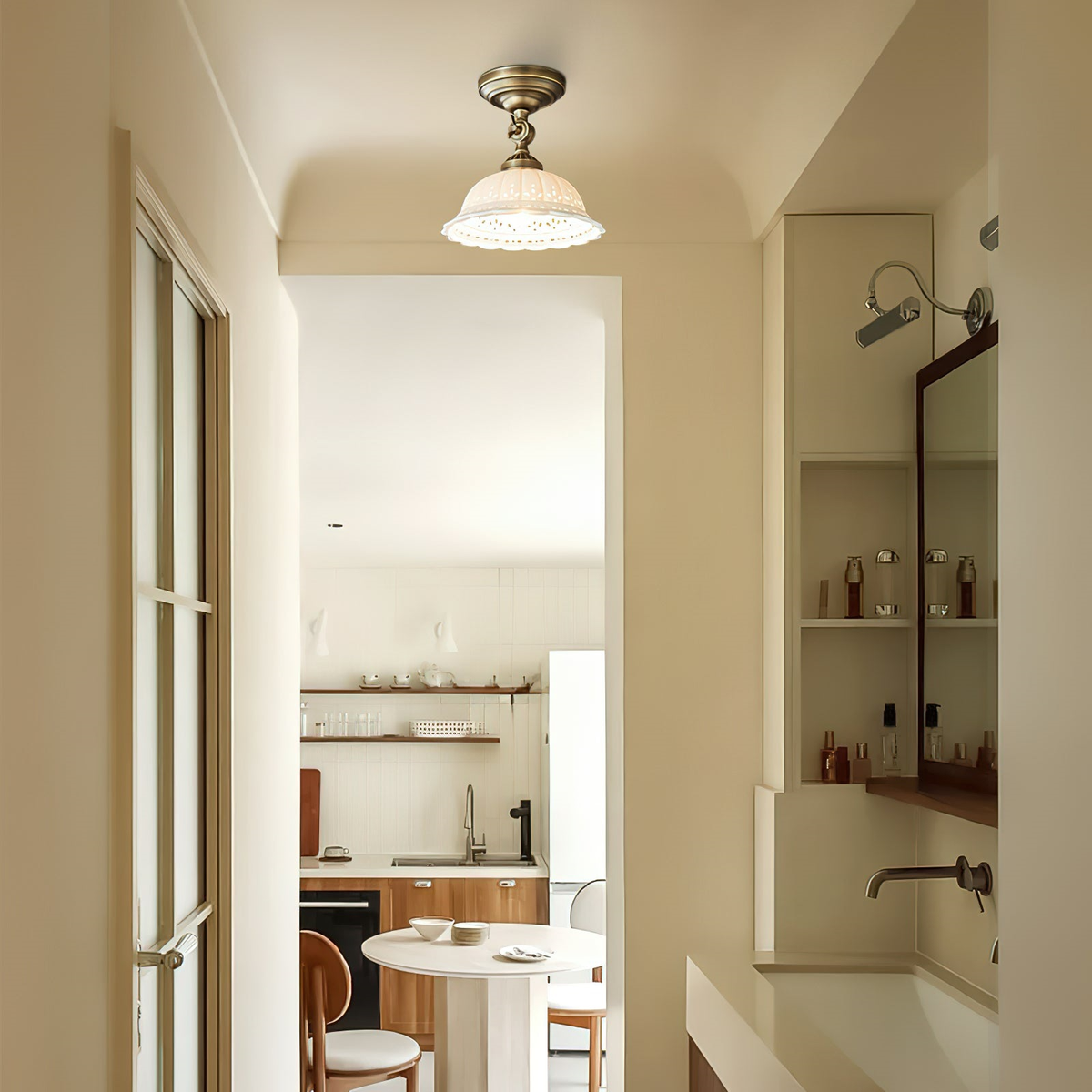 Ceramic dome light in antique brass hanging in a narrow hallway, with a bathroom and a kitchen visible beyond, from Clérachic.