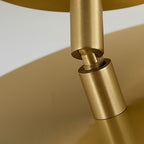 Close view of the swivel joint on this Clérachic brass ceiling light, where the stem turns to tilt the disc head.