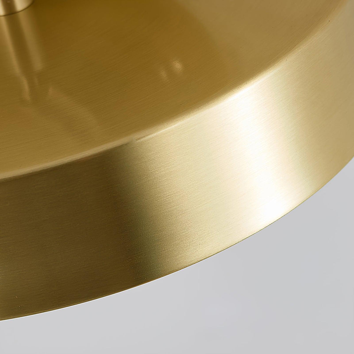 Close view of the brushed brass rim on this Clérachic ceiling light, showing the fine grain of the metal.