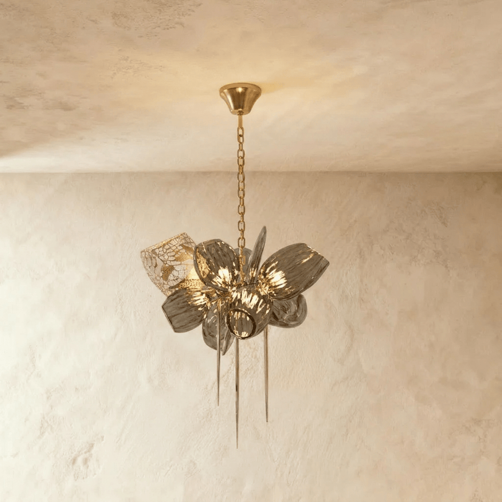 Clérachic compact chandelier with ribbed grey glass petals, one brass lattice shade and three hanging spikes on a brass chain.