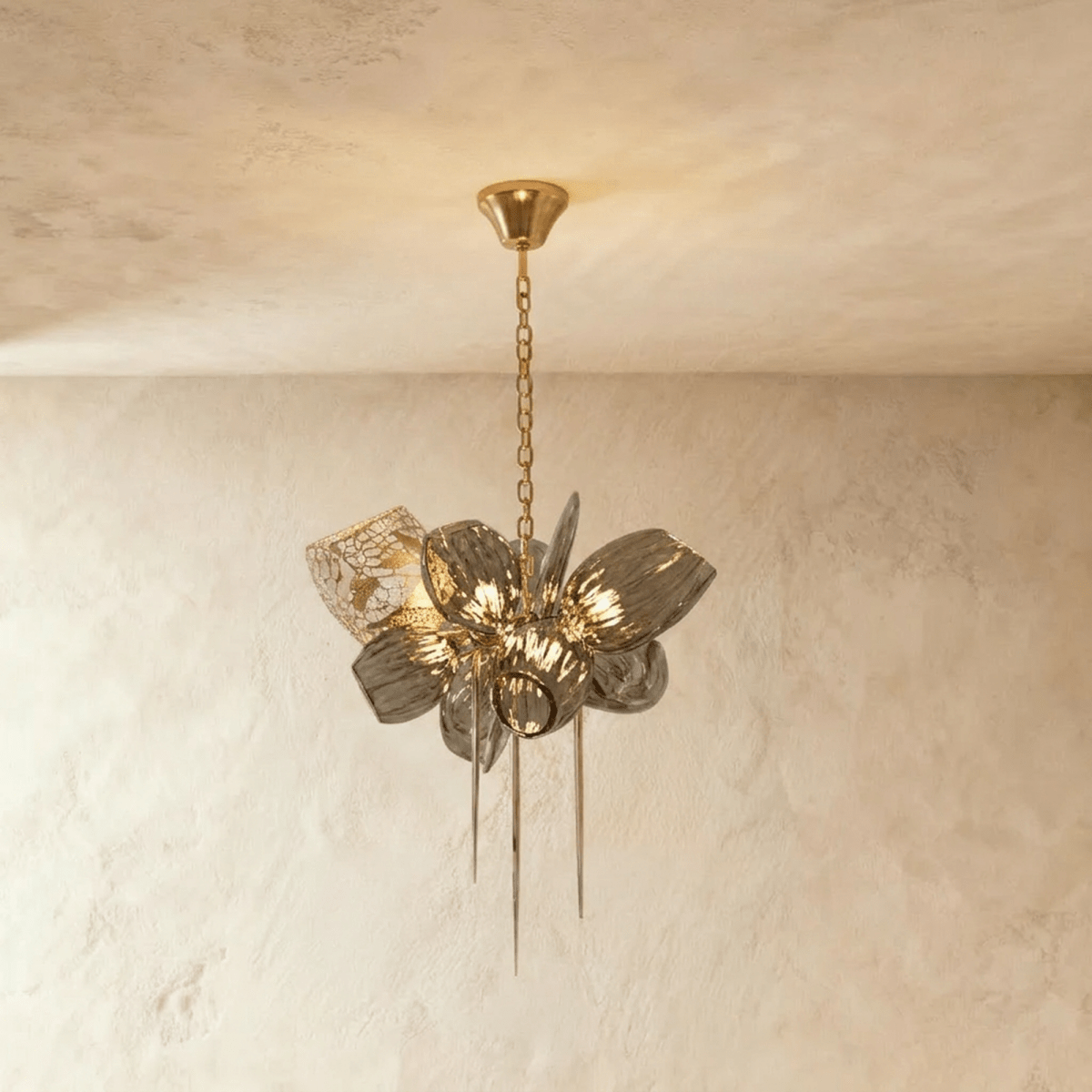 Clérachic compact chandelier with ribbed grey glass petals, one brass lattice shade and three hanging spikes on a brass chain.