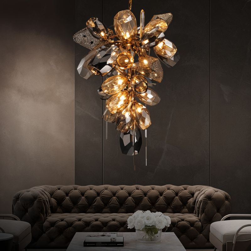 Clérachic faceted cognac and smoked glass chandelier over a deep tufted sofa in a dark, moody lounge with a marble table.