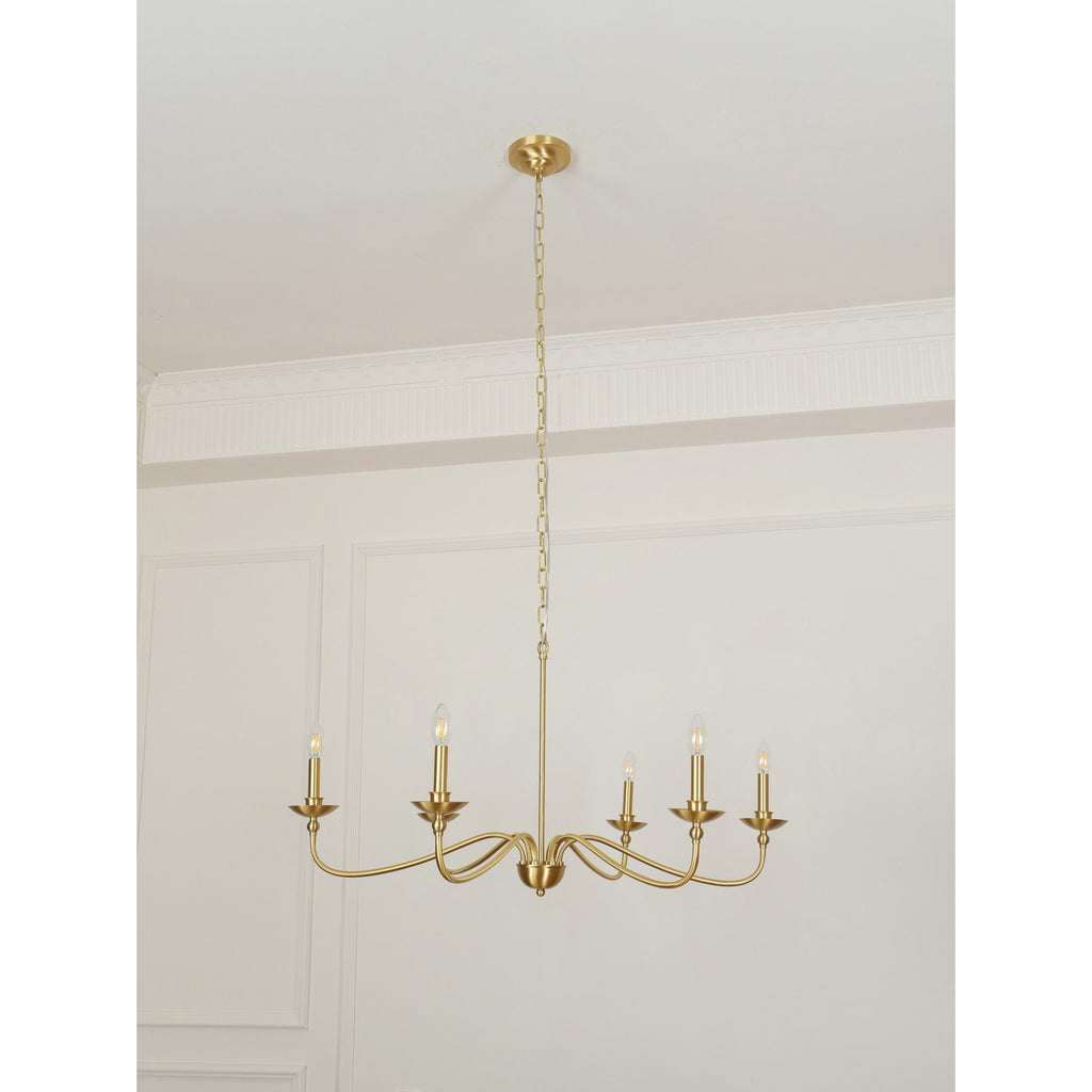A Clérachic brass chandelier with a long rod and chain, unlit, hanging in a room with a white moulded wall.