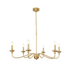 A Clérachic brass chandelier on white, lit, with curved arms rising to candle bulbs and a gold ceiling plate above.