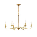 A six-arm Clérachic brass chandelier on white, with lit candle bulbs on swept arms and a looped chain above.