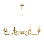 An eight-arm Clérachic brass chandelier on white, its swept arms in layers, each ending in a lit candle bulb.
