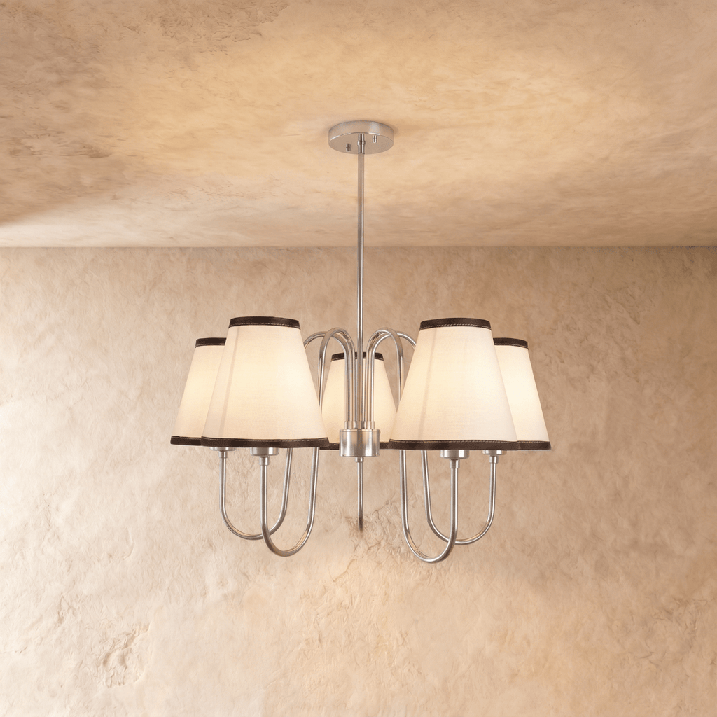 Clérachic chandelier in chrome, five ivory shades with charcoal trim hanging from a slender rod.