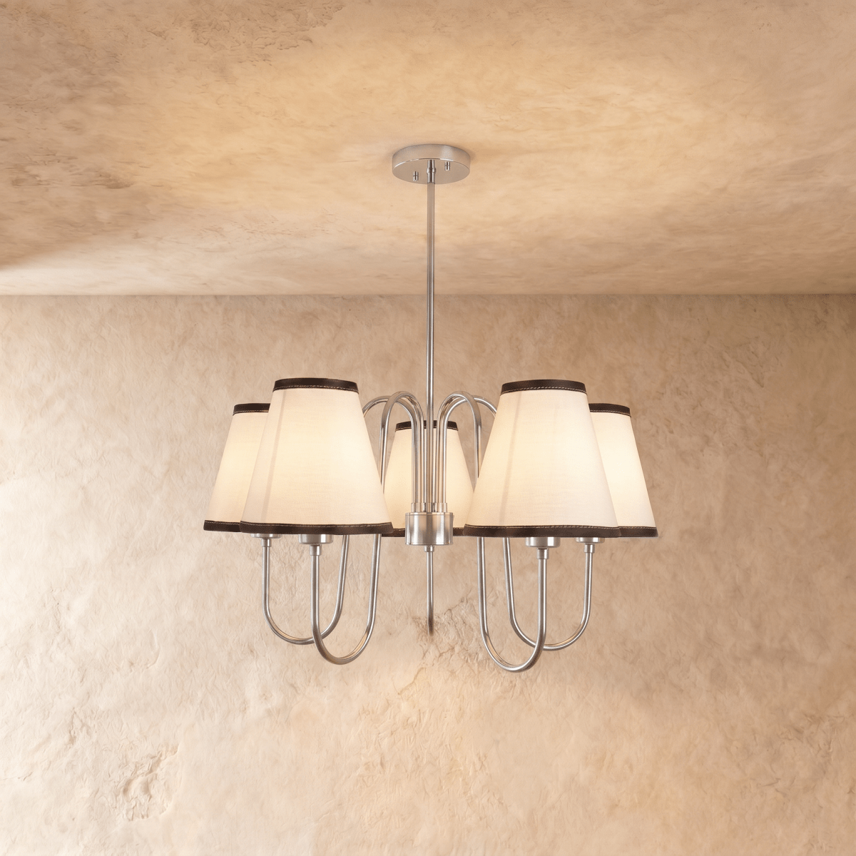Clérachic chandelier in chrome, five ivory shades with charcoal trim hanging from a slender rod.