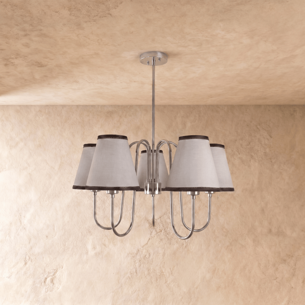 This chrome Clérachic chandelier is shown at an angle, its five shades catching the light evenly.
