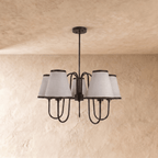 A black Clérachic chandelier viewed straight on, its five shades arranged evenly around the frame.