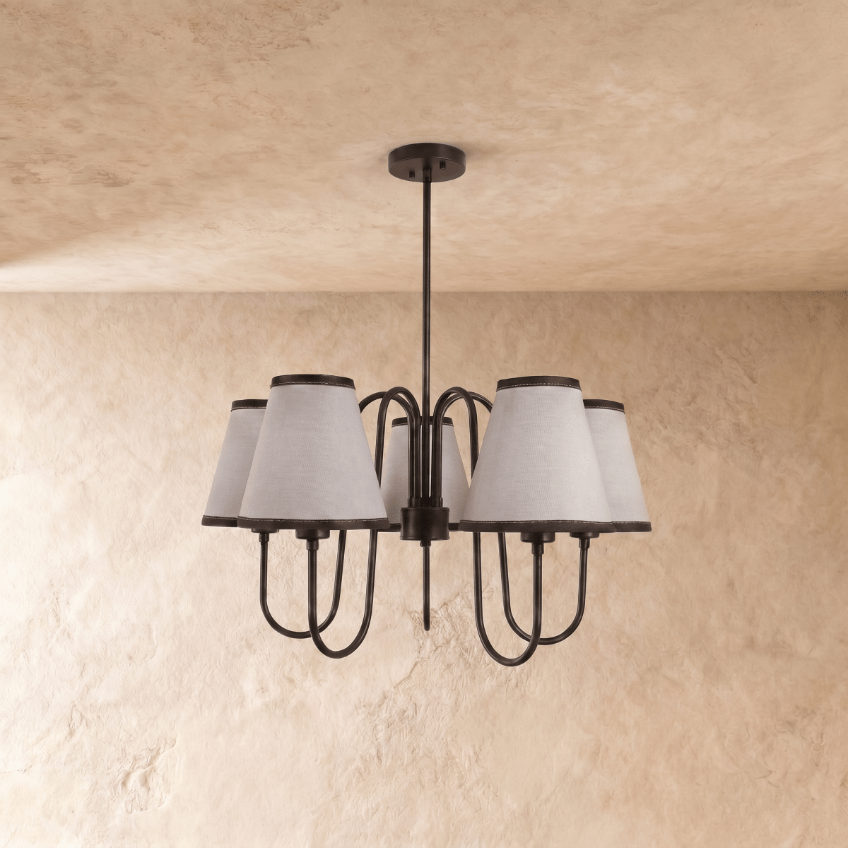 A black Clérachic chandelier viewed straight on, its five shades arranged evenly around the frame.