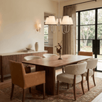 This chrome Clérachic chandelier lights a bay-window dining table set with leather and shearling chairs.