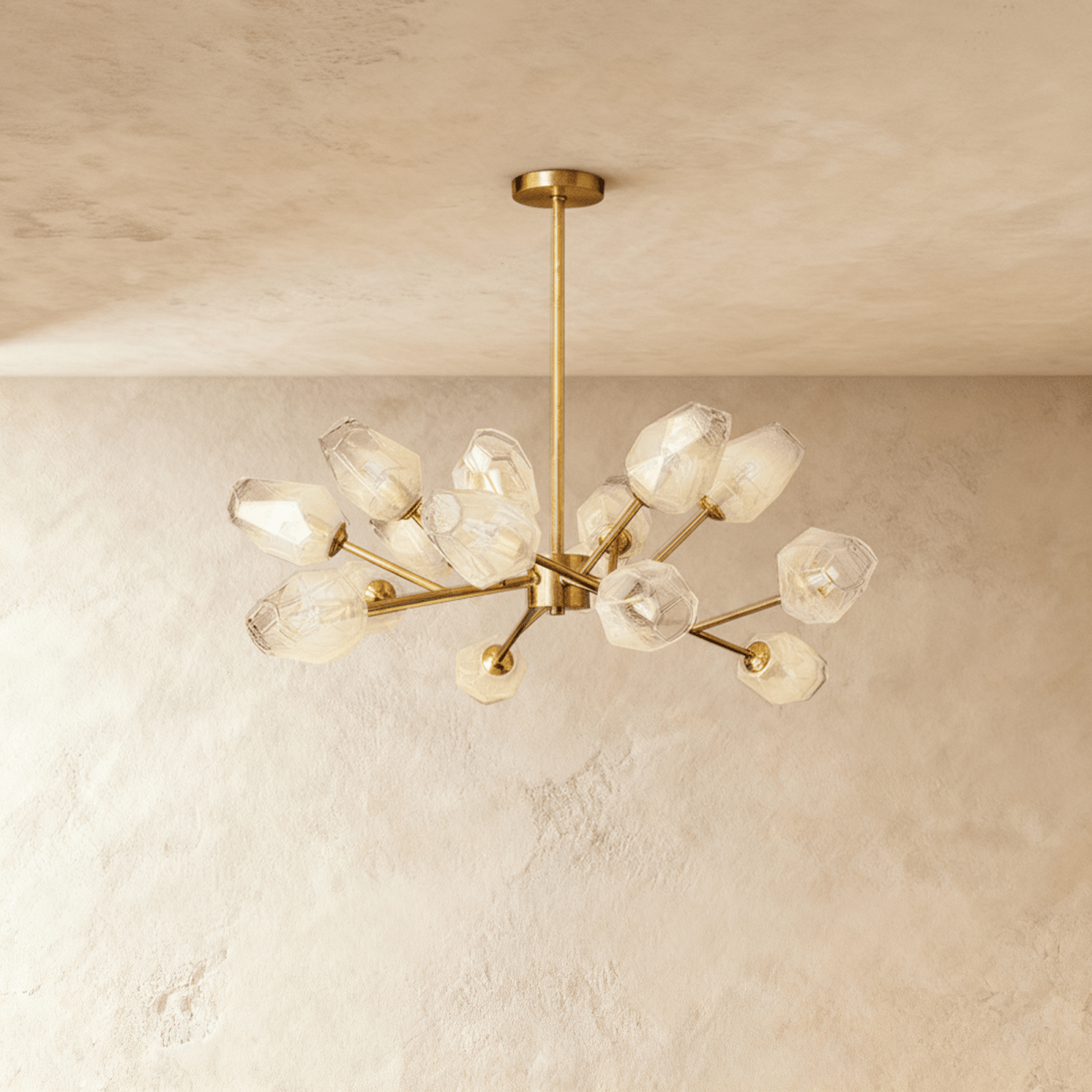 Clérachic chandelier in brushed brass with frosted glass shades on straight arms and a round ceiling canopy.