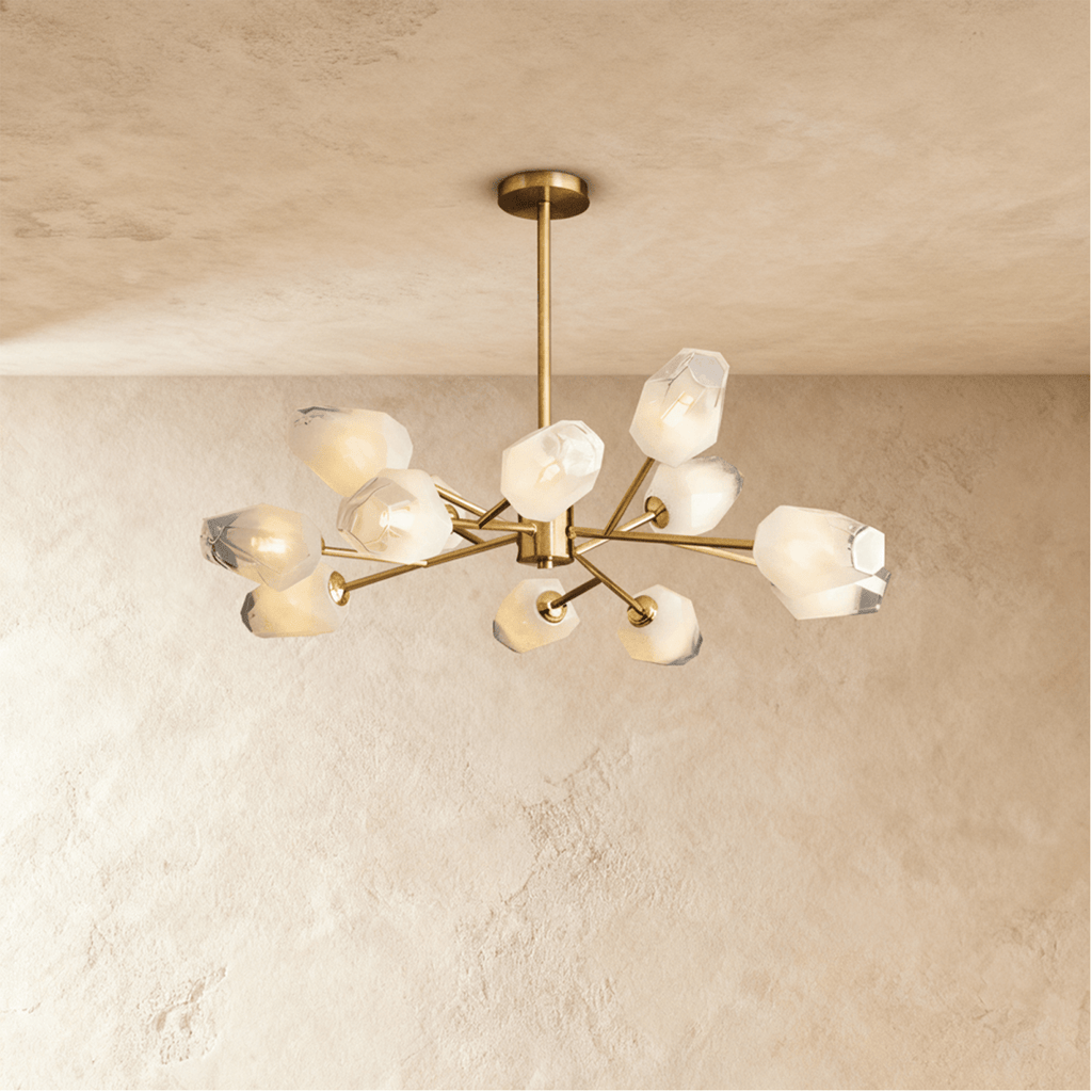 Clérachic twelve-head brass chandelier with frosted faceted glass shades and a slim rod, lit softly against limewash.