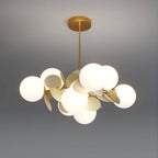 Clérachic brass-finished chandelier lit warm, with frosted glass globes among cream metal discs on a ceiling rod.