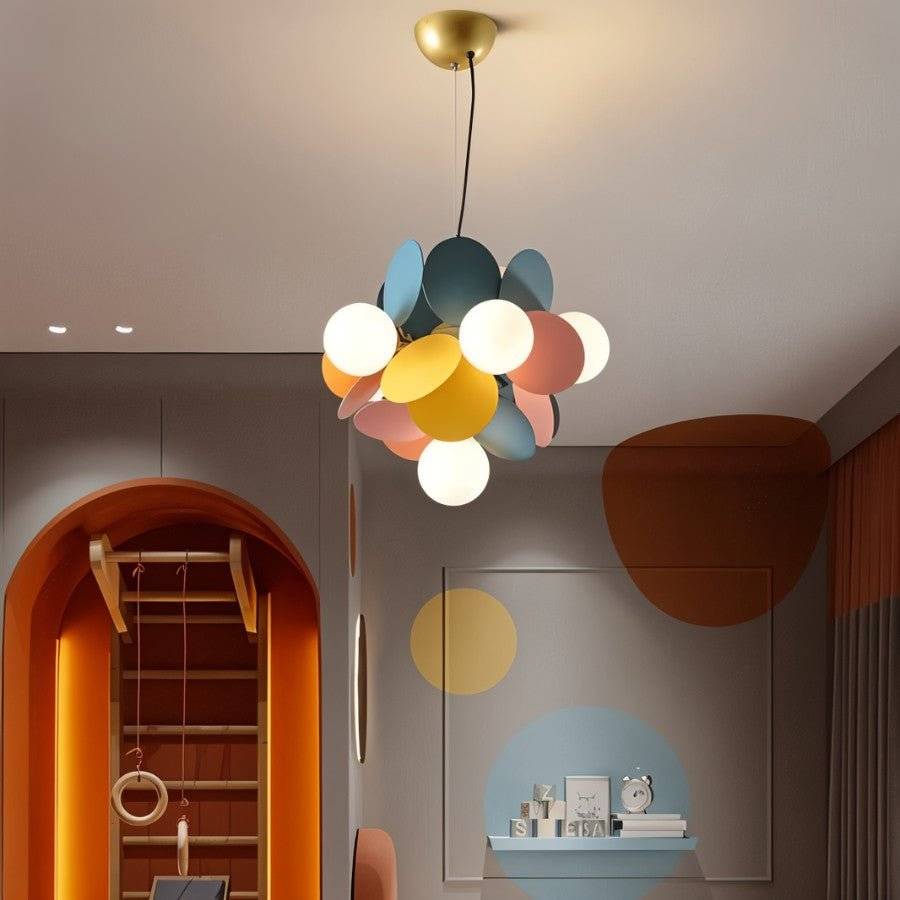 Clérachic small pendant of frosted globes and blue, yellow and pink discs on a black cord, in a playroom.