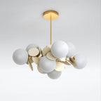 Clérachic unlit chandelier with grey-white glass globes and cream metal discs on a brass frame and ceiling rod.