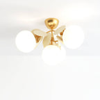Clérachic ceiling light with three frosted glass globes, cream metal discs and a brass canopy.