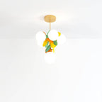 Clérachic tall hanging chandelier of frosted globes with green, orange and yellow discs on a brass rod.
