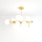 Clérachic wide chandelier of frosted glass globes and cream metal discs on fine brass arms and a rod.