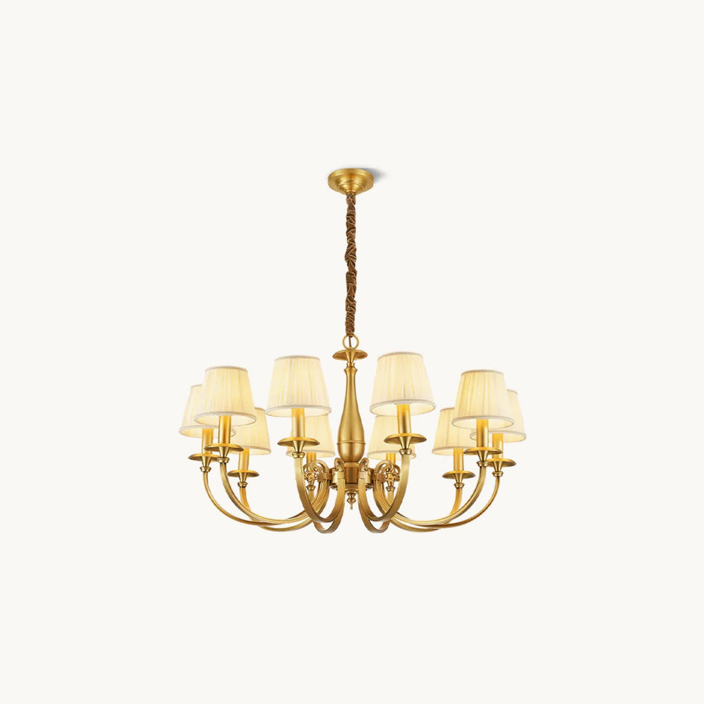 This Clérachic brass chandelier on a plain white backdrop, with curved arms, a slim baluster stem and pleated white fabric shades.