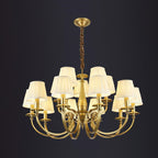 A two-tier Clérachic brass chandelier on a dark backdrop, with pleated shades in an upper and a lower ring.