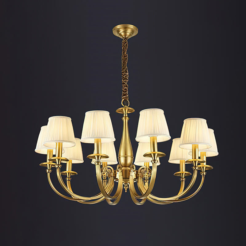 This Clérachic brass chandelier on a dark backdrop, with eight pleated white shades and a baluster stem on a wrapped chain.