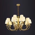 A tiered Clérachic brass chandelier, ten pleated shades in two rings, on a dark charcoal backdrop.