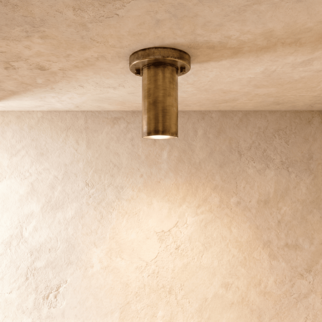 Clérachic ceiling light in vintage brass, its cylindrical spotlight recessed flush against the ceiling.