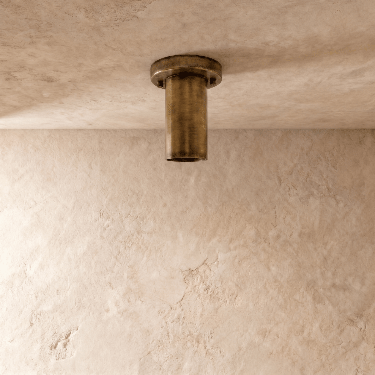 This vintage brass Clérachic ceiling light is shown from below, its round lens glowing softly.