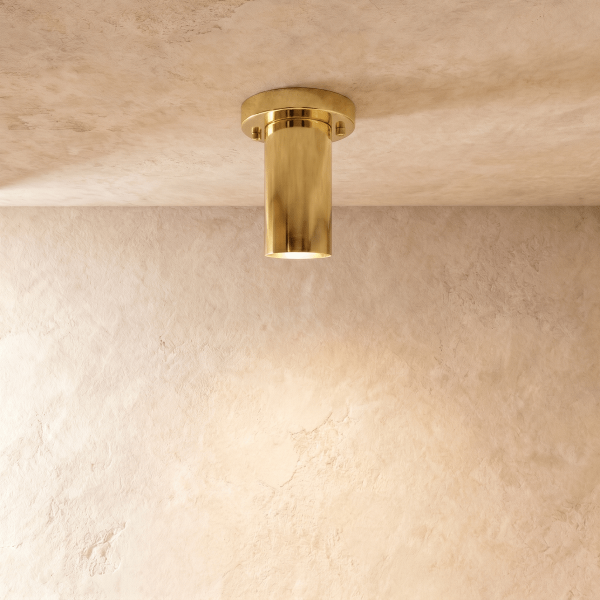 Clérachic ceiling light in polished brass, a slim cylinder flush-mounted against a plaster ceiling.