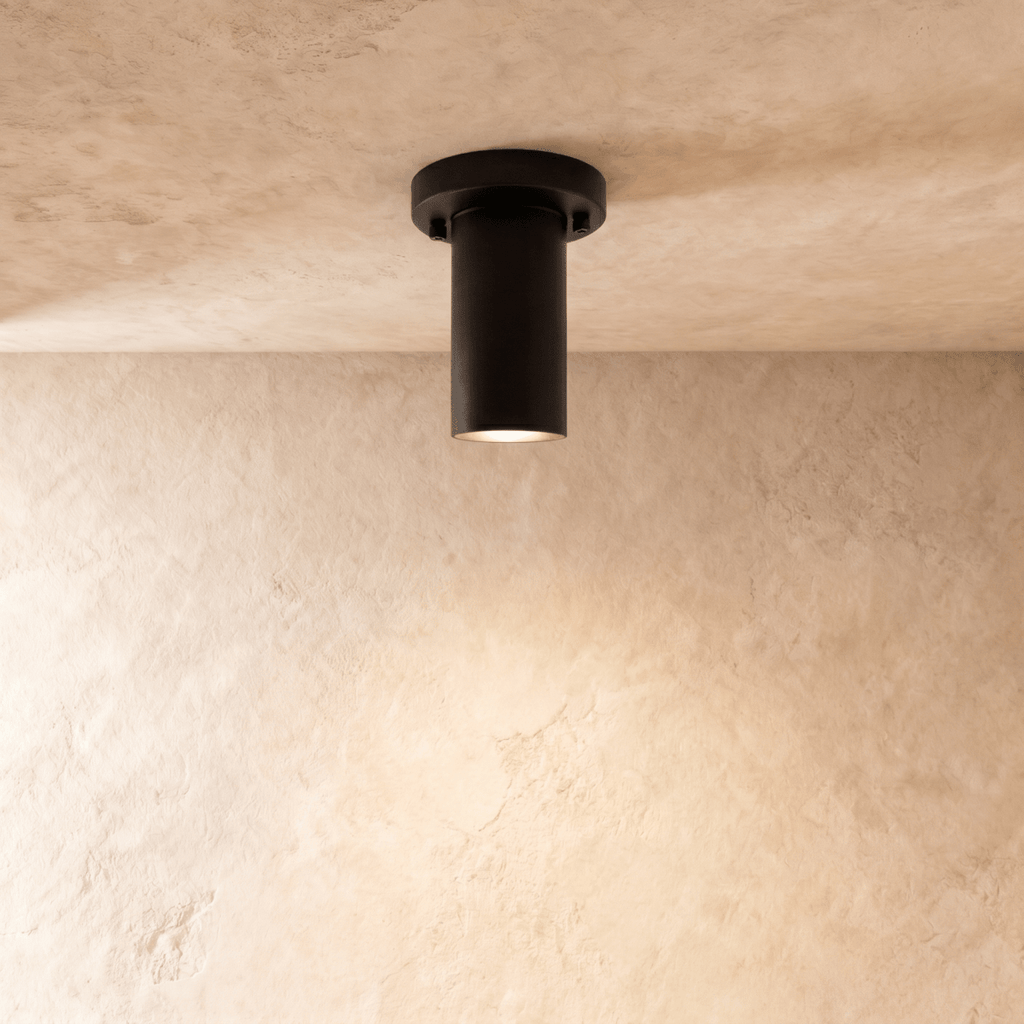 Clérachic ceiling light in matte black, its cylindrical spotlight flush-mounted against the ceiling.