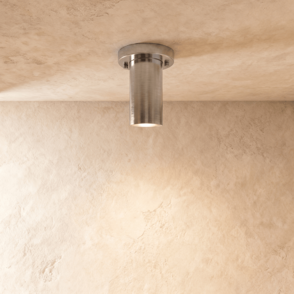 Clérachic ceiling light in chrome, a slim cylinder flush-mounted against a plaster ceiling.