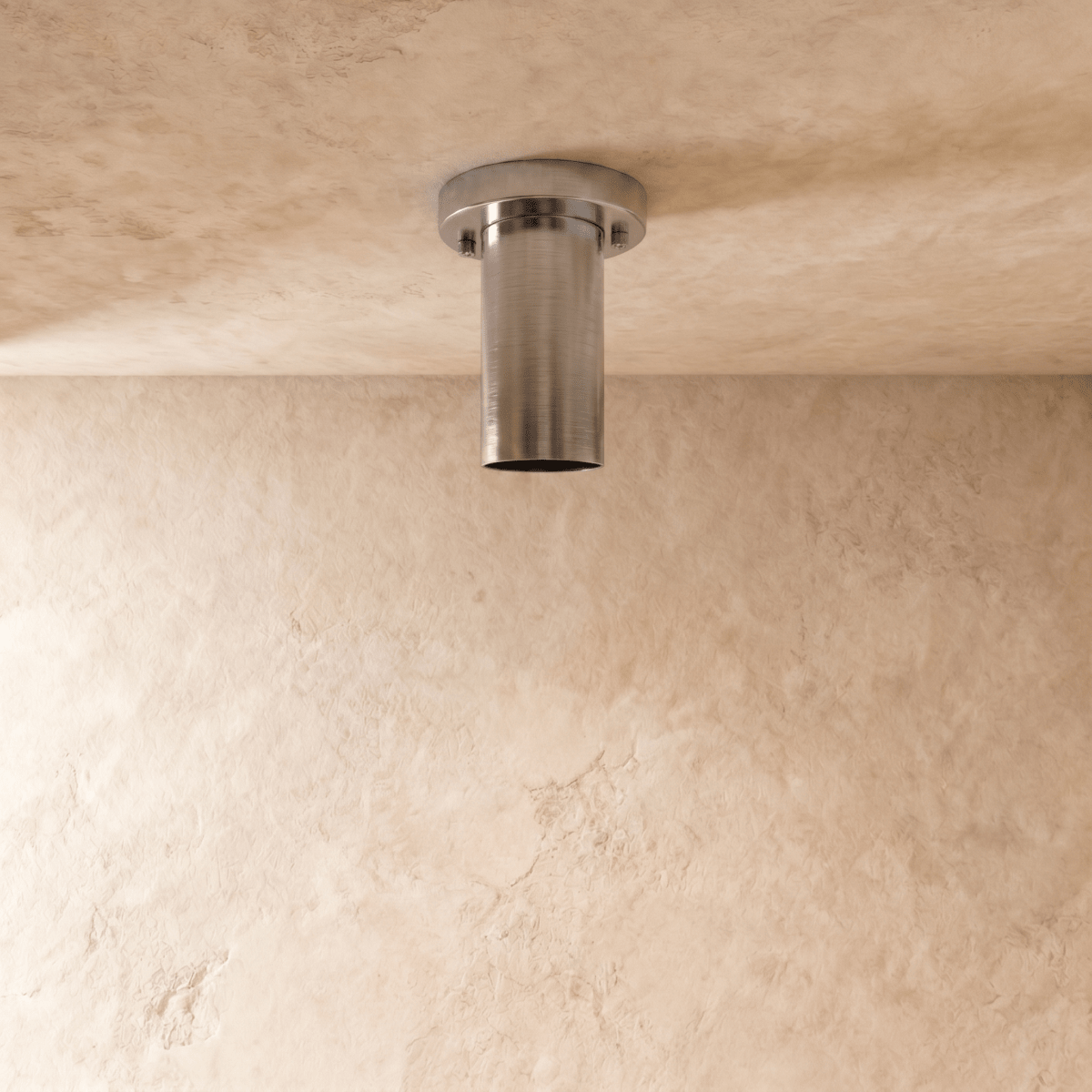 This chrome Clérachic ceiling light is shown from below, its round lens catching the light.