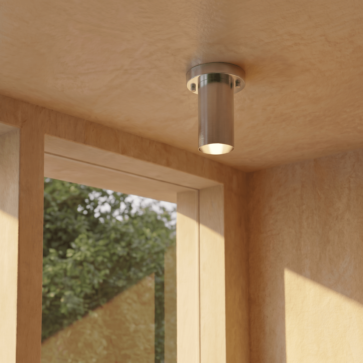 This chrome Clérachic ceiling light lights a wood-paneled corner beside a window onto greenery.