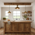 In a farmhouse kitchen with a rustic timber island and two small pendants, a Clérachic brass dome ceiling light hangs near the centre beam.