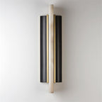 The Clérachic Brass-Edged Shield Wall Sconce unlit on a pale wall, an alabaster bar standing proud of two curved bronze shields.
