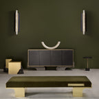 A pair of Clérachic Brass-Edged Shield Wall Sconces mounted either side of a dark sideboard on an olive-green wall.