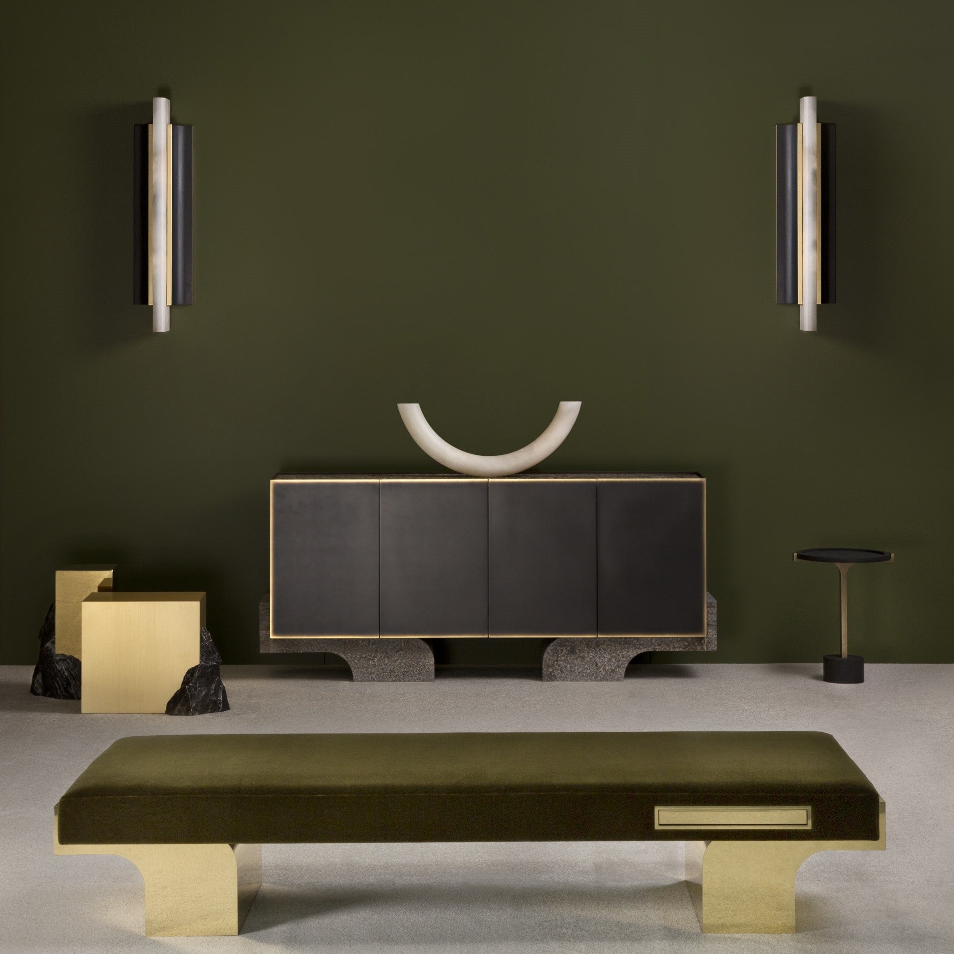 A pair of Clérachic Brass-Edged Shield Wall Sconces mounted either side of a dark sideboard on an olive-green wall.