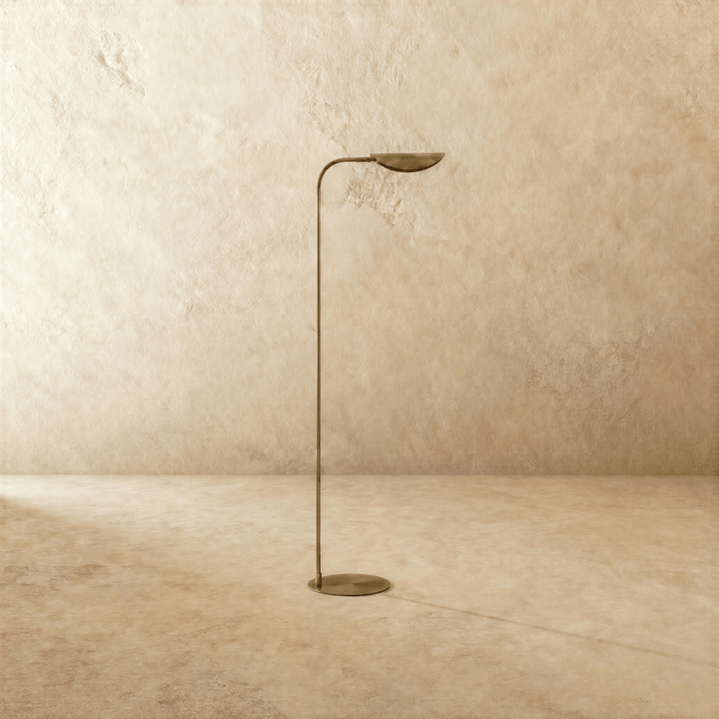 This vintage brass Clérachic floor lamp is shown from another angle, its leaf shade angled toward the ceiling.