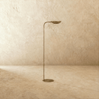 This vintage brass Clérachic floor lamp is shown from another angle, its leaf shade angled toward the ceiling.