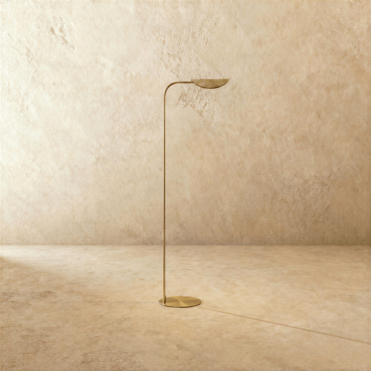 This polished brass Clérachic floor lamp is shown from a different angle, the leaf shade tilted upward.