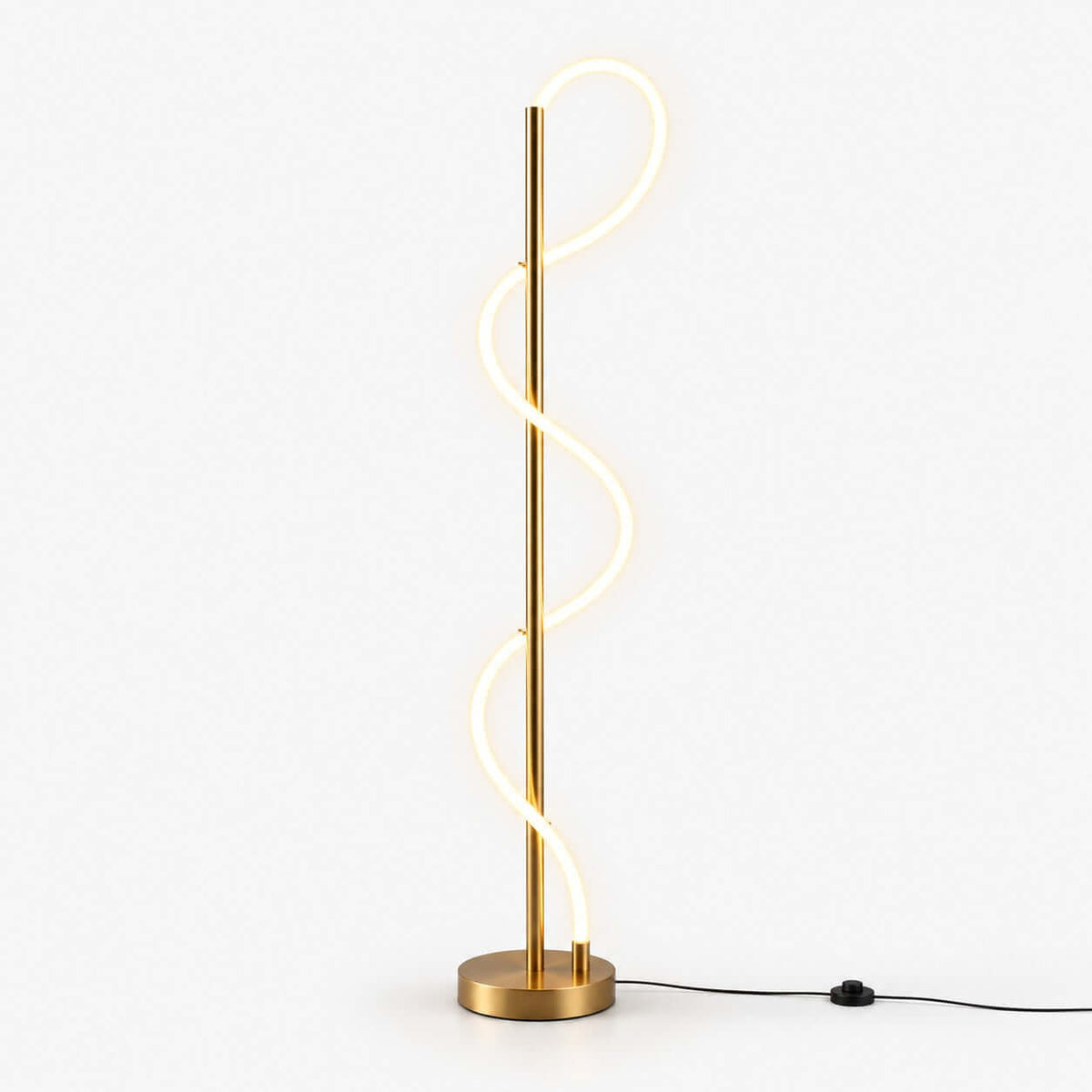 Glowing S-shaped silicone strip curling up a slim brass pole on a round brass base, with a black foot-switch cable on this Clérachic floor lamp.
