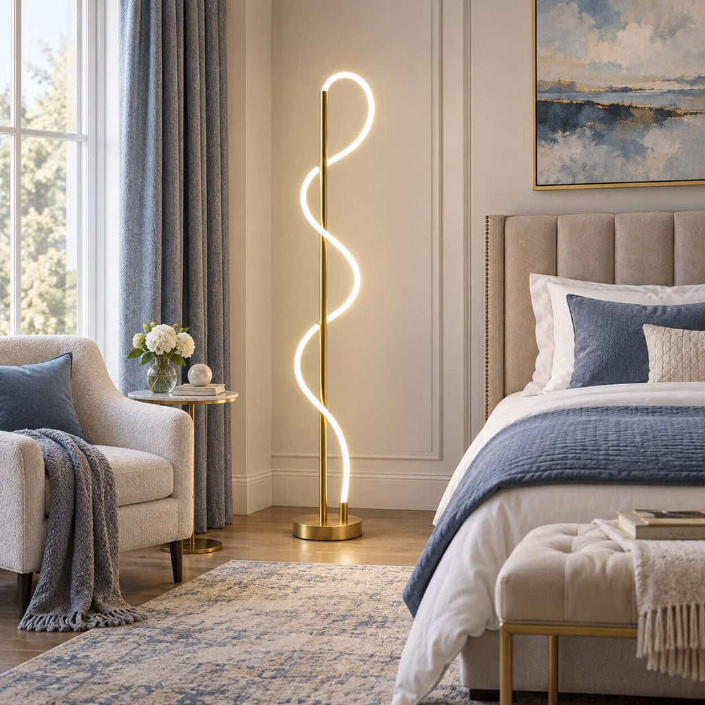 Next to a bed with blue bedding and a tufted headboard, this Clérachic floor lamp glows against a panelled wall and a seascape print.