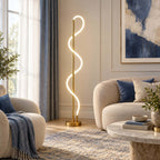 By a window with blue curtains, this Clérachic floor lamp shows its lit silicone curve above a boucle sofa and a marble table.