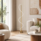 Unlit, the milky white silicone strip winds up the brass pole of this Clérachic floor lamp, beside a boucle sofa and a round table.